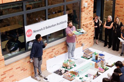 A student and an architect present their design to the Newark School of Architecture and Interior Design students and faculty.