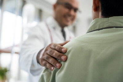 A physician with his hand on a patient's shoulder. (GettyImages-2190519000)