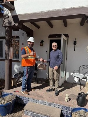 Everyone is all smiles as Ezee Fiber installs first customer to its high-speed fiber network in Santa Fe, New Mexico.  Shown left to right: Angel Reyes, senior manager, field operations, Ezee Fiber, and Mr. Scott Brandt, Santa Fe, NM.