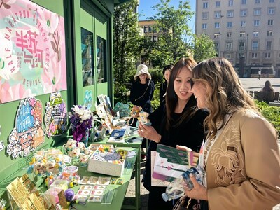 Photo shows a curator of the pop-up event introducing thematic exhibits to a visitor in Milan, Italy on April 25.