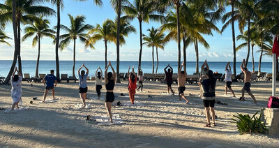 Blazesoft employees participate in a group yoga session during the company’s annual retreat in the Caribbean as part of the company’s ongoing wellness initiatives that promote healthy lifestyles, work-life balance, and team connection. Courtesy of Blazesoft. (CNW Group/Blazesoft)