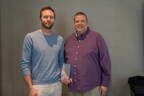 Conor Steadman, Senior Partner Success Manager at F-Secure (left) accepts the Vendor Marketing Award from Charlie Conway, CEO of ResearchFirst (right).