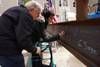 Residents Jacob and Diane Munn leave their mark on the Cabot Park Village renovation and expansion during the recent topping-off ceremony.