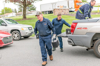 East Penn volunteers unload batteries from one of the vehicles at the company’s Power2Recycle event.