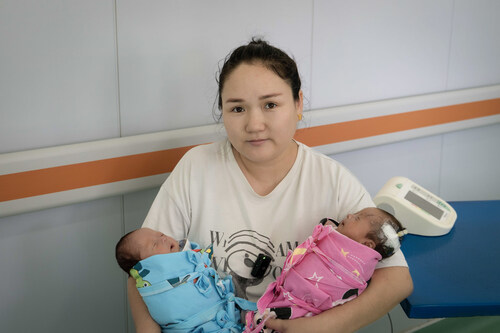 In Ulaanbaatar, Mongolia, new mother Otgonchimeg holds her twin babies, some of the first premature infants ever screened for the blinding eye condition, retinopathy of prematurity, with assistive artificial intelligence.
