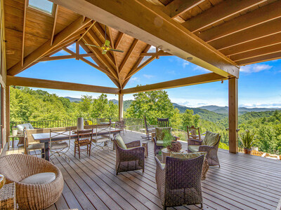A sprawling, covered terrace offers cool mountain breezes and sublime views of the surrounding mountains. On a clear day, views can extend to the state of Tennessee. NorthCarolinaLuxuryAuction.com.