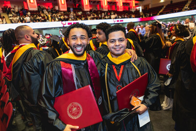 Graduates with their diplomas.