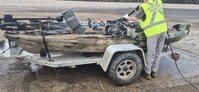 A Manitoba Watercraft Inspector decontaminates a kayak that failed inspection for not meeting Clean, Drain, Dry requirements. (CNW Group/Fisheries and Oceans Canada Ontario &amp; Prairie Region)