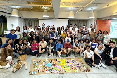 AXA employees engage in painting activities alongside participants with Down syndrome and hearing impairments, and take part in therapy dog sessions, fostering positive social connections through art and animal assisted therapy.