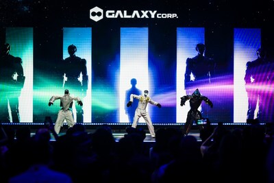Three humanoid robots perform a K-POP choreography on stage during the finale of the UN 'AI for Good' Summit, with the Galaxy Corp. logo displayed prominently in the background
