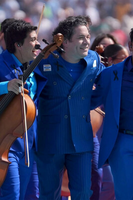 Gustavo Dudamel and his musicians at the World Cup Final in the blue BARABAS Palma Pinstripe Suit, made by the independent Los Angeles menswear brand.