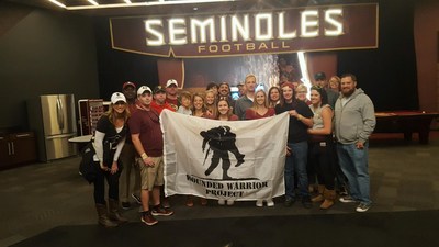 Wounded warriors and their guest pose for a picture at the Seminole football field during a Wounded Warrior Project event.