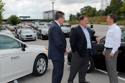 Paul Evon of Enterprise, Rob Wynkoop of Purdue and Brad Rhorer of Subaru of Indiana discuss the first delivery of cars to Purdue as part of a new lease program through Enterprise. (Purdue University photo)
