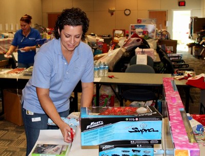 A WellCare associate wraps gifts as part of WellCare's "Santa Cause" initiative.