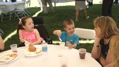 ITC Midwest President Krista Tanner talks with Wish Child Rylie and her brother at an ITC picnic this past summer to raise funds for Riley and her family to take a vacation on the Disney Cruise Line(R).  The Make-A-Wish Iowa chapter's foundation has granted wishes to more than 3,000 children with life-threatening medical conditions since 1987 and currently grants a wish in Iowa about every other day.
