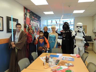 Costumed characters from "Frozen" and "Star Wars" surprise young Jedi in training, Adan, with a Chewbacca plush toy during the "Bear Hugs Toy Drive" donation at Miller Children's & Women's Hospital Long Beach.