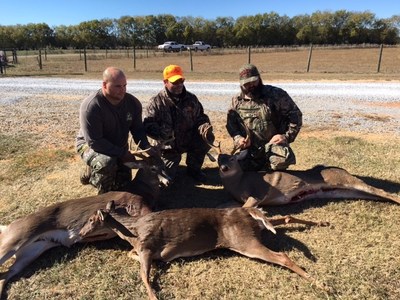 Wounded Warrior Project veterans take a picture around their catch from deer hunting.