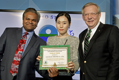Obama Administration official Mathy Stanislaus, Assistant Administrator for EPA's Office of Land and Emergency Management, Jane Kang, Head of Product Stewardship, LG U.S., John Taylor, Vice President of Public Affairs, LG U.S., Receiving EPA Gold Tier Recycling Award