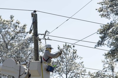 A Georgia Power lineman works in icy conditions to restore power following Winter Storm Helena.