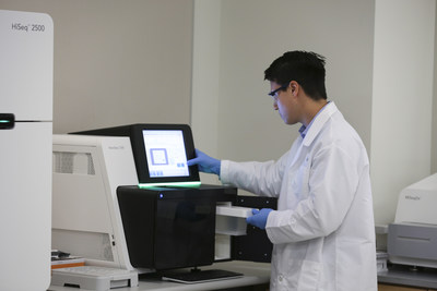 Scientist preparing Illumina Nextseq 500 system.