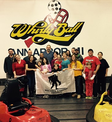 Wounded veterans and their families pose for a picture after playing Whirlyball.