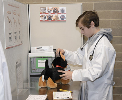 A student from Ste. Genevieve du Bois school in St. Louis plays the role of veterinarian in Nestle Purina's new storefront at JA BizTown in Chesterfield, Missouri.