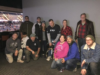 A group of wounded warriors pose for a picture at the Ontario Reign hockey game.
