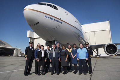 Employees gather under United's new 777-300ER entitled the "New Spirit of United".
