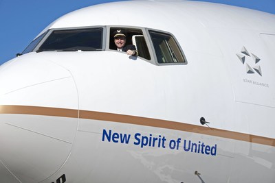 United pilot waves from United's new 777-300ER entitled the "New Spirit of United".