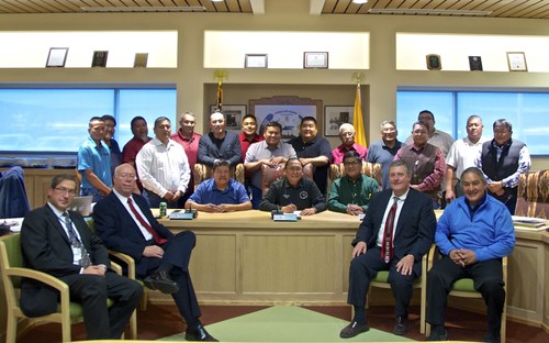 Acoma Pueblo Governor Kurt Riley, surrounded by members of Tribal Council and Acoma Business Enterprises, enthusiastically signs business agreement with Bright Green Group on December 16, 2016.