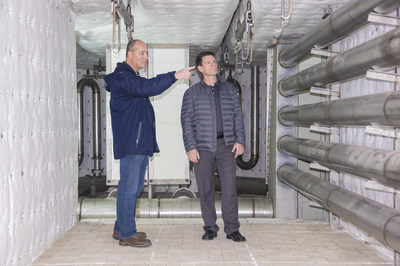 At the Galesburg, KS facility, the president of Tank Connection, Vince Horton, among others, inspects a new porcelain enamel furnace that is being installed.