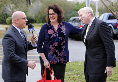 Kirk Saville, svp, corporate communications at BJ's Wholesale Club (right) surprises Robin Smith, teacher at Edmund A Burns Elementary School (center) with meteorologist Josh Marthers live on-air during WCBD-TV's News 2 at Midday on Thursday, Jan. 26, 2017, in Mount Pleasant, S.C. with the announcement that BJ's has donated over $100,000 to help fund classroom projects in Summerville, Charleston and the surrounding areas through DonorsChoose.org. (Mic Smith/AP Images for BJ's Wholesale Club)