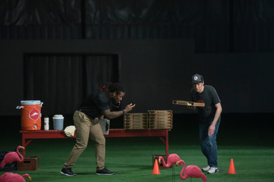 Professional football running back DeAngelo Williams (left) trains a delivery rookie (right) at the Pizza Hut Delivery Combine, in advance of the Big Game - the restaurant company's busiest day of the year. (AP Images for Pizza Hut)