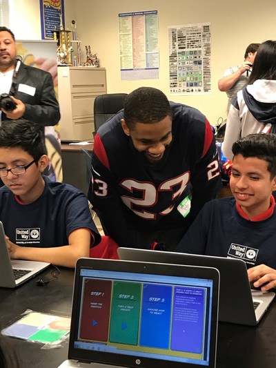 Houston Texans safety Kurtis Drummond works with a student from Pilgrim Academy.