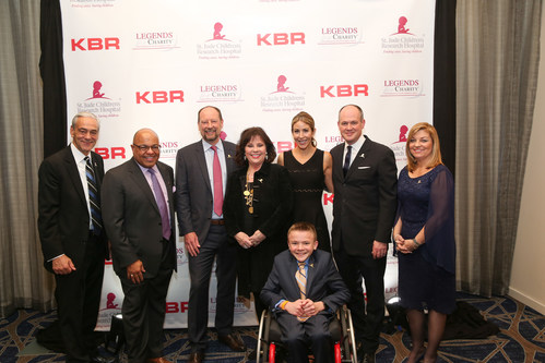 L-R: Richard Shadyac, Jr., President and CEO of ALSAC, the fundraising and awareness organization for St. Jude Children's Research Hospital; Mike Tirico, NBS Sports; Stuart Braddie, KBR Inc. President & CEO; Cheri Summerall, wife of belated Pat Summerall; Suzy Shuster, wife of Rich Eisen; Rich Eisen, NFL Network and award honoree; Cheryl DeLeonardis, Ocean 2 Ocean Productions and Event Producer; (front row)  St. Jude patient Austin. Photo credit: Ashkan Image