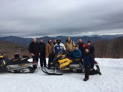 Wounded Warrior Project veterans pose on the top of a snowy mountain during a connection event.