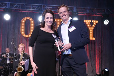 Nick Mowbray, President of ZURU, accepts the Outdoor Toy of the Year (TOTY) award for Bunch O Balloons at the Toy Industry Association's Annual Toy Of The Year Awards gala from Shirley Price, TOTY Committee Chair and COO of Funrise.