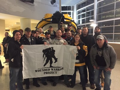 Wounded Warrior Project veterans stop to pose for a group picture before attending the Pittsburgh Penguins game.