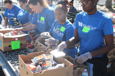 WellCare volunteers pack boxes at a March 11 mobile food pantry hosted by Feeding Tampa Bay at the George A. Bartholomew North Tampa Community Center in Tampa, Fla.