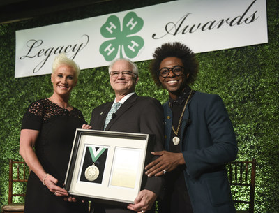 Chef, author and TV personality Anne Burrell, left, and chef and multimedia host Lazarus Lynch, right, present the Distinguished Alumni Medallion award to Dr. Faustino Bernadett, president of IPA Healthcare, during the 8th annual National 4-H Council Legacy Awards on Tuesday, March 21, 2017, in Washington. (Kevin Wolf/AP Images for National 4-H Council)