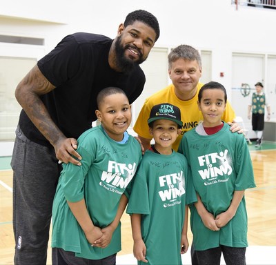 Celtics power forward Amir Johnson (L) with Ed Milano, VP, Sun Life Financial, and YMCA youth participants of Sun Life Fit to Win program.