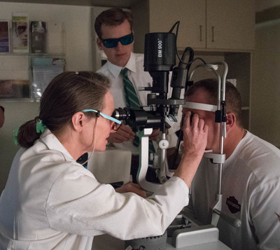 Wills Eye Hospital's Carol Shields, MD examines patient (clinical study participant). Oncology research fellow, wearing protective eyewear, also observes. Photo courtesy: Roger Barone / Wills Eye Hospital.