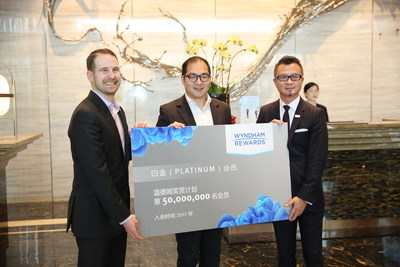 Noah Brodsky, Wyndham Hotel Group senior vice president of worldwide loyalty and engagement, left, and Leo Liu, Wyndham Hotel Group president and managing director for Greater China, right, congratulate Samuel Xu on becoming Wyndham Rewards' 50 millionth member. Mr. Xu enrolled in the award-winning program while staying at the newly opened Wyndham Grand Xiamen.