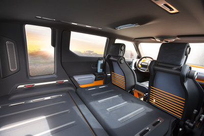 Rear passenger seats fold completely flat to expand storage capacity. Blue-colored storage boxes carry small items, while orange-painted areas serve as open holds.