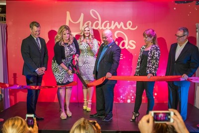 Trisha Yearwood cuts the ribbon at Madame Tussauds Nashville's grand opening event. (Pictured from L to R: Bill Cody, Grand Ole Opry announcer/host; Trisha Yearwood, American country music artist; JeanPierre Dansereau, GM of Madame Tussauds Nashville; Laurel Bennett, VP of Tourism Sales at Nashville Convention & Visitors Corporation; and Gregg Goodman, president of The Mills/A Simon Company.)