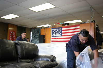 The RoomPlace employees unpack new furniture at a local Chicago firehouse. This is the second consecutive year The RoomPlace is making a sizable donation to honor the service of first responders.