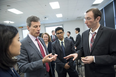 Zachary Newhart (electrical engineering ’17) describes a 3-D printed transformer case held by UTC Aerospace Systems Vice President of Engineering for Sensors and Integrated Systems Mauro Atalla (engineering mechanics, Ph.D. ’96).