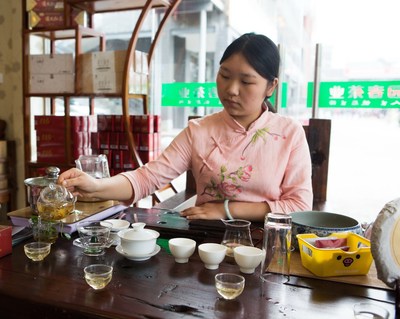 A tea specialist preparing tea for visitors during the Expo