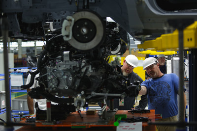 Toyota R&D employees study the underside of a vehicle at the newly opened TMNA R&D Purchasing and Prototype Development centers in York Township, Mich.