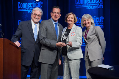 Virginia Kozlowski, Executive Director of Visit New Haven, Connecticut Lodging Association and REX Development, receives the 2017 Connecticut Governor's Tourism Award for Tourism Legacy Leader. From left: Randy Fiveash, Director, Connecticut Office of Tourism; Governor Dannel P. Malloy; Virginia Kozlowski; Catherine Smith, Commissioner, Connecticut Department of Economic and Community Development.